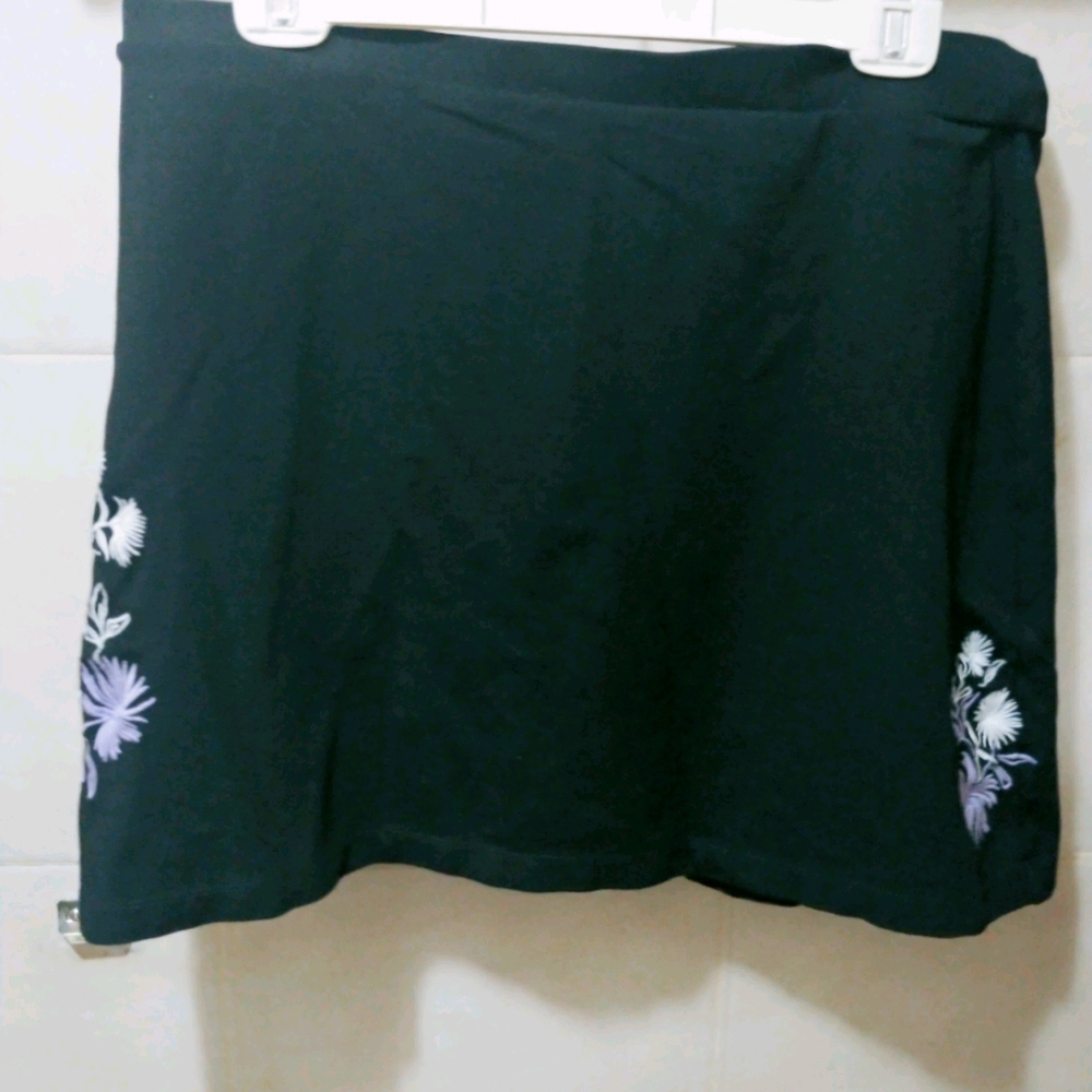 Black skirt with purple and white flowers.